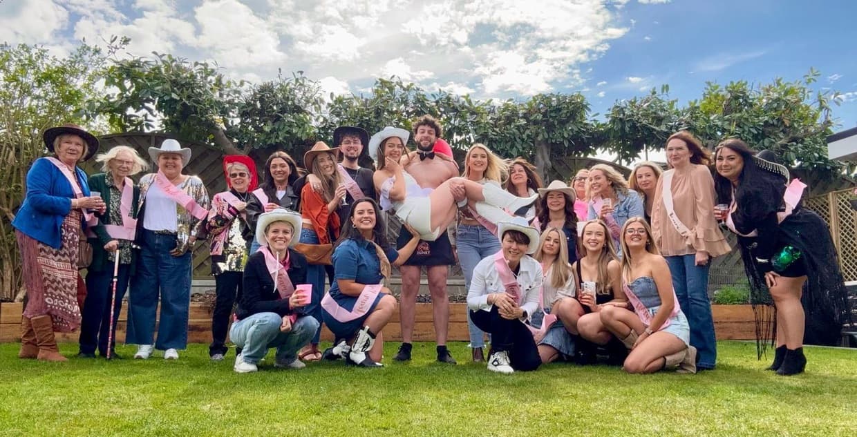 Team of butlers posing with clients